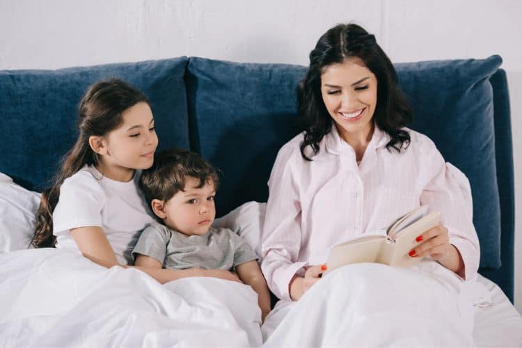 woman and kids reading together