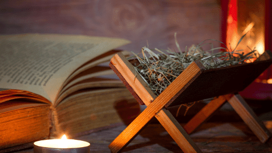 Bible with manger and candle