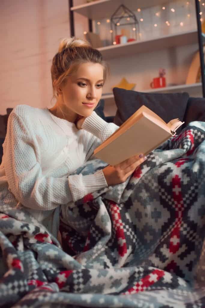 woman reading a cozy Christmas book