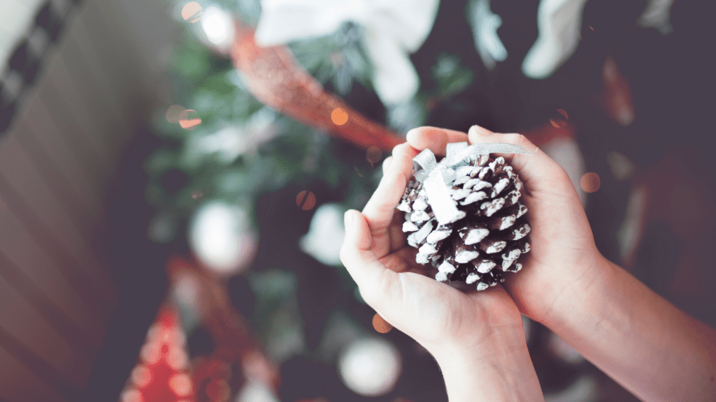 hands holding a homemade Christmas ornament