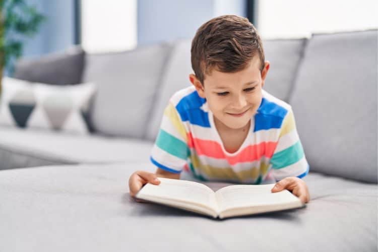 little boy reading a bible