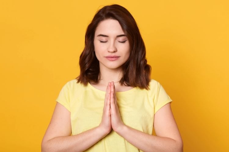 woman with her hands crossed in prayer