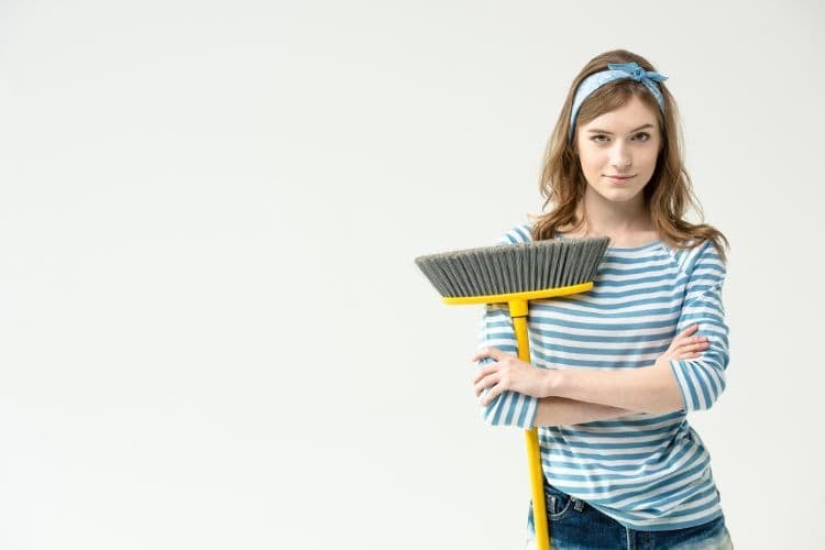 woman holding a broom
