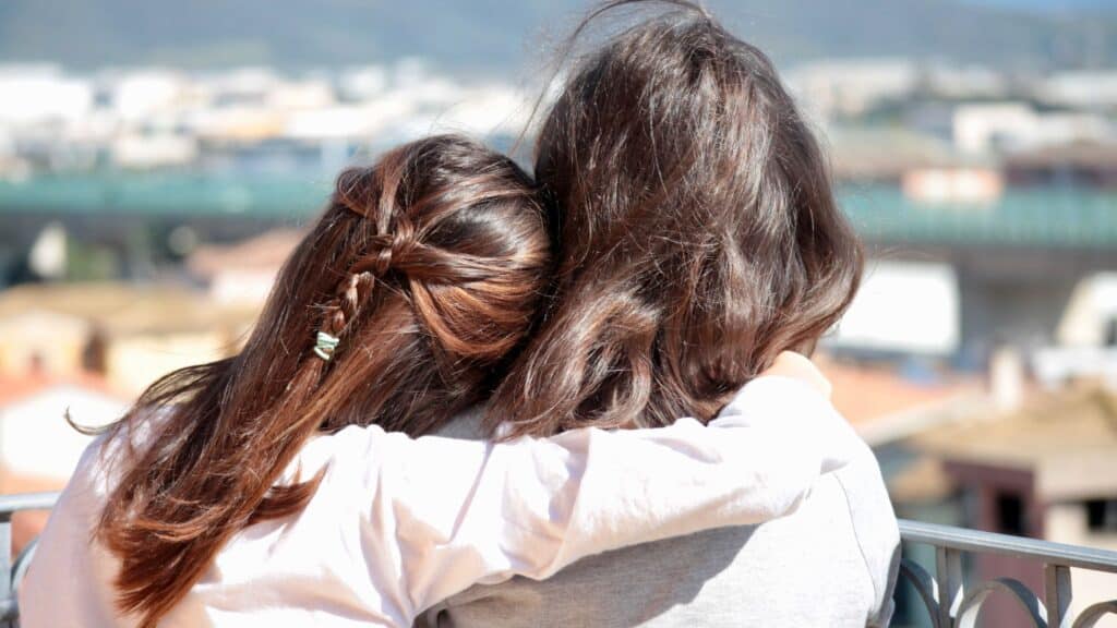 back view of two women with heads together