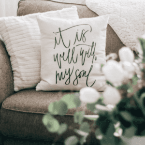 it is well pillow cover displayed on a couch