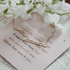 "amazing grace" necklace against a Bible background