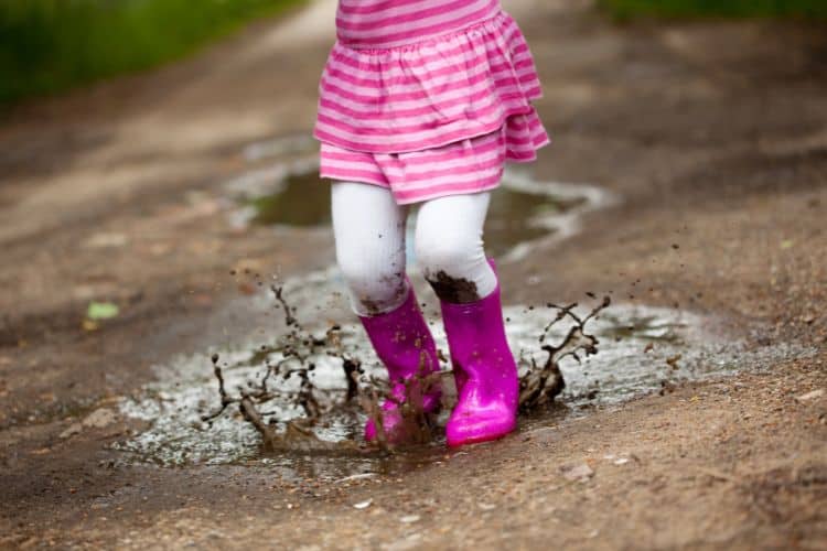 little girl stomping in the mud