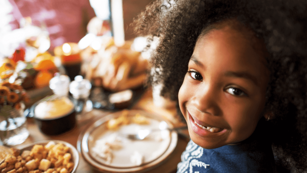smiling girl at Thanksgiving | thanksgiving activities for kids