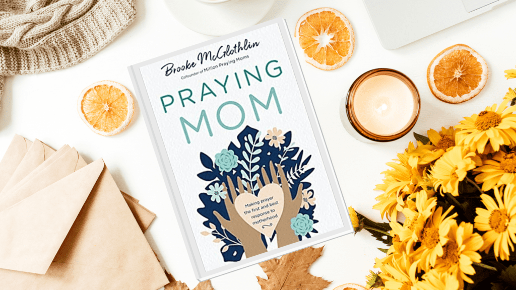 Praying Mom book on table with yellow flowers