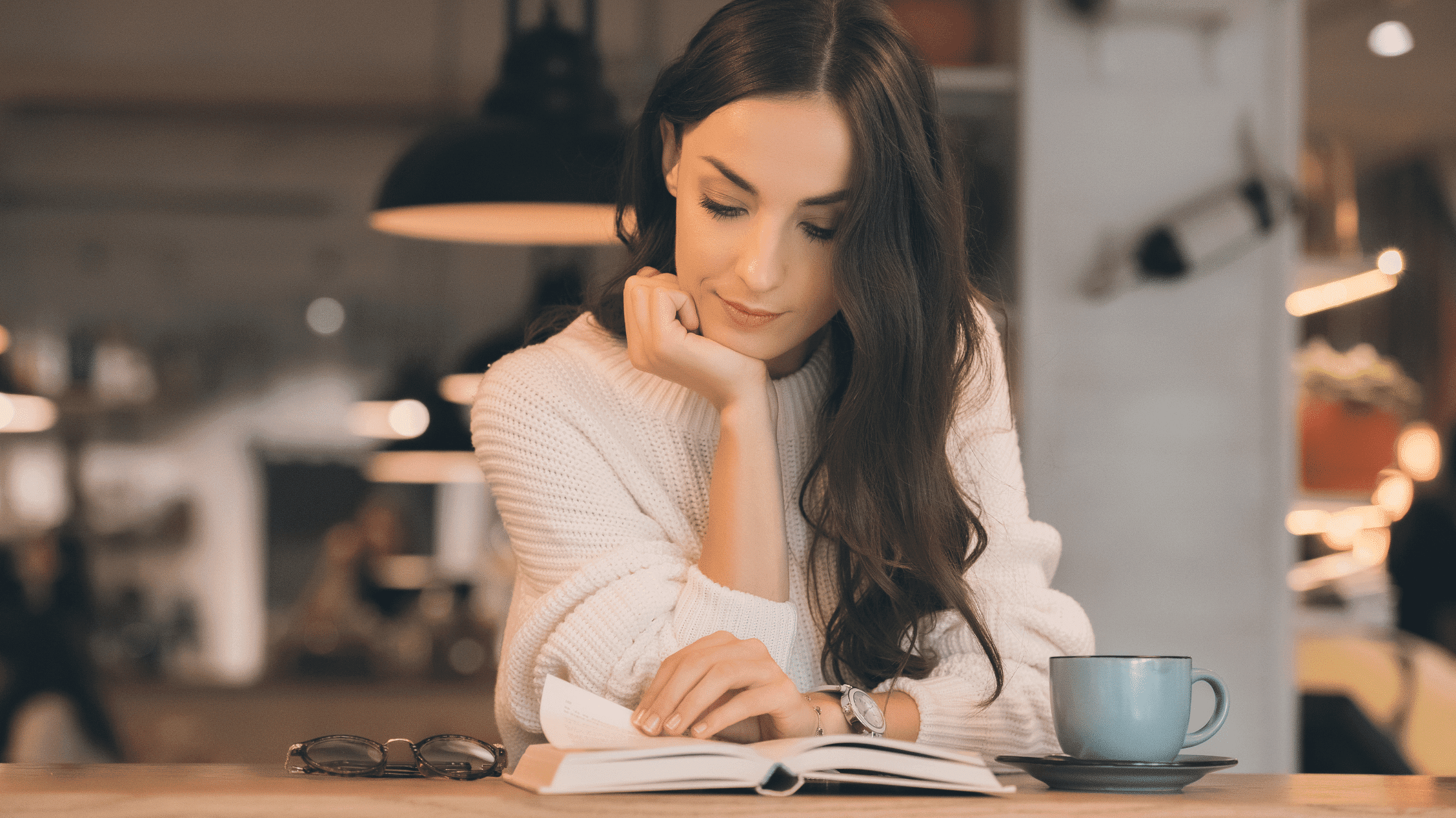 woman reading the Bible in a coffee shop