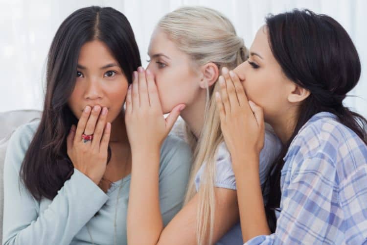 three woman whispering in gossip