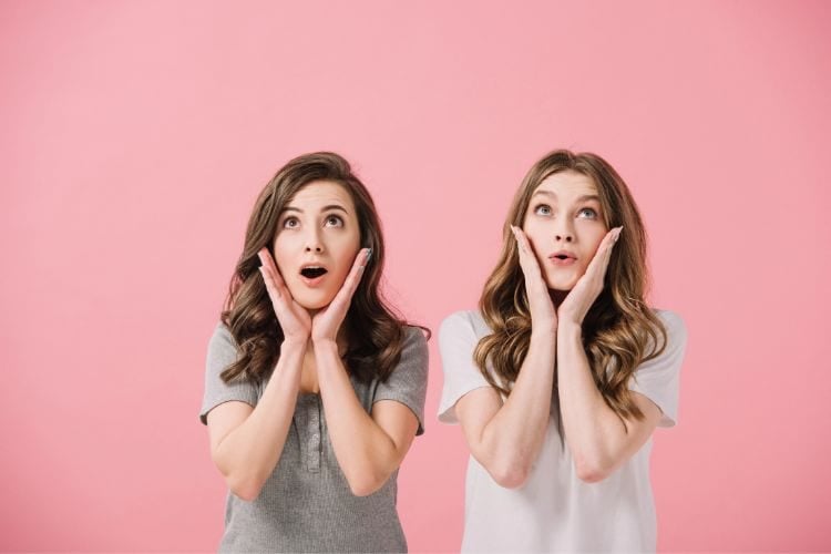 two women with hands on their faces in surprise