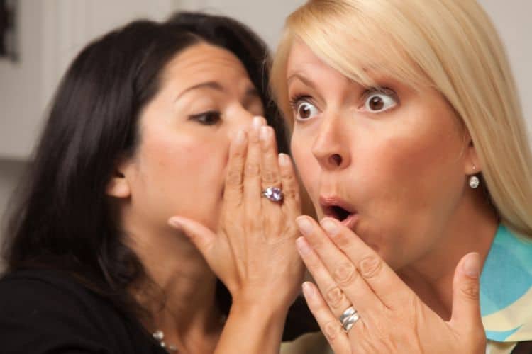 woman whispering gossip