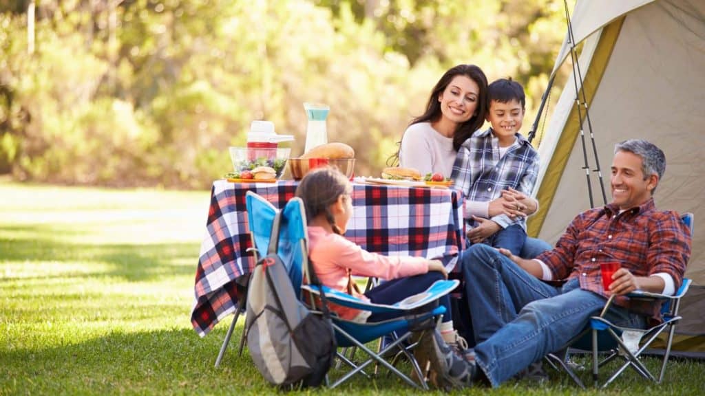 family gathered in front of a tent