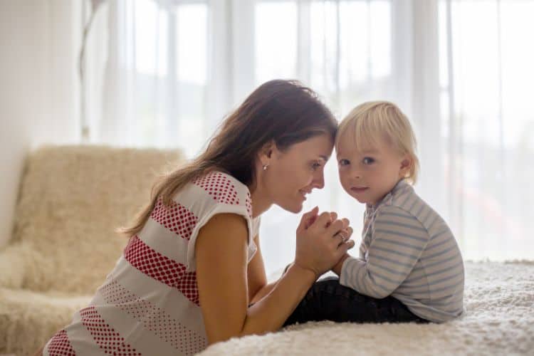 mother praying with her son