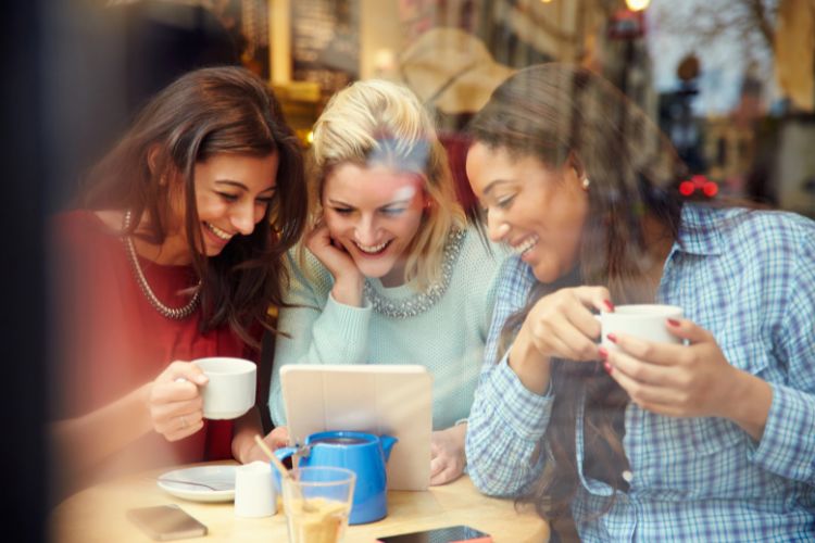 women sharing homeschooling advice in a coffee shop