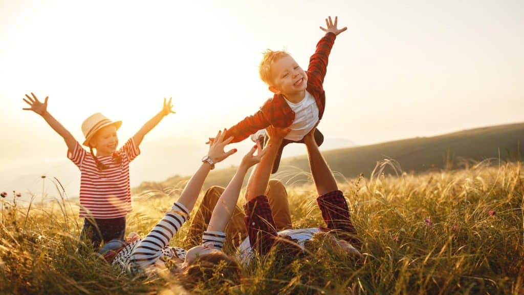 smiling family playing outside