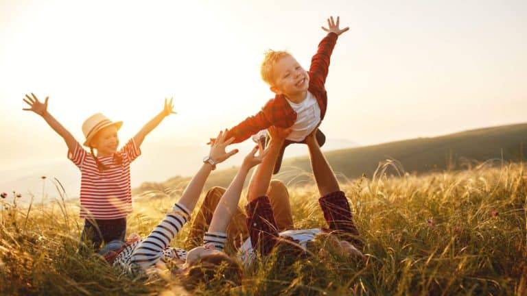 smiling family playing outside