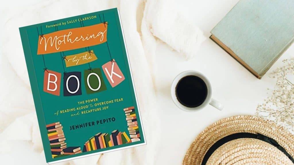 cover of mothering by the book along with a cup of coffee on a white background