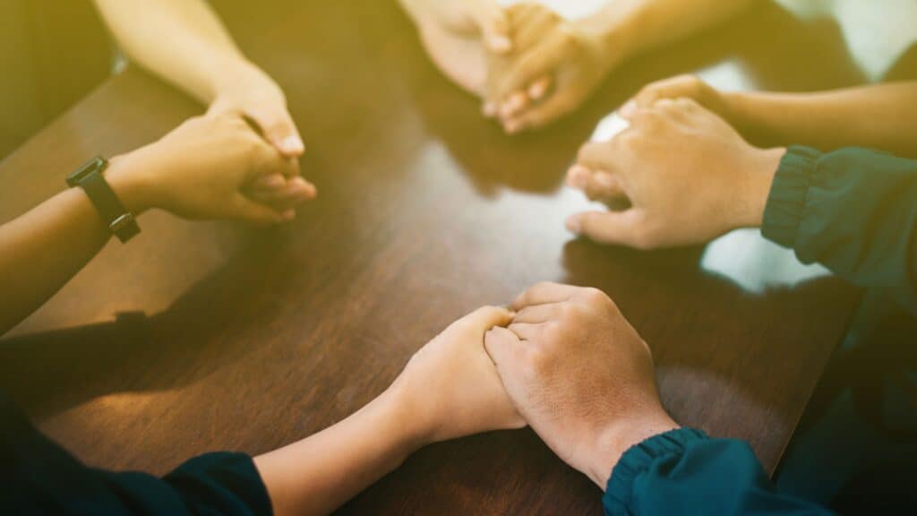 hands clasped in prayer