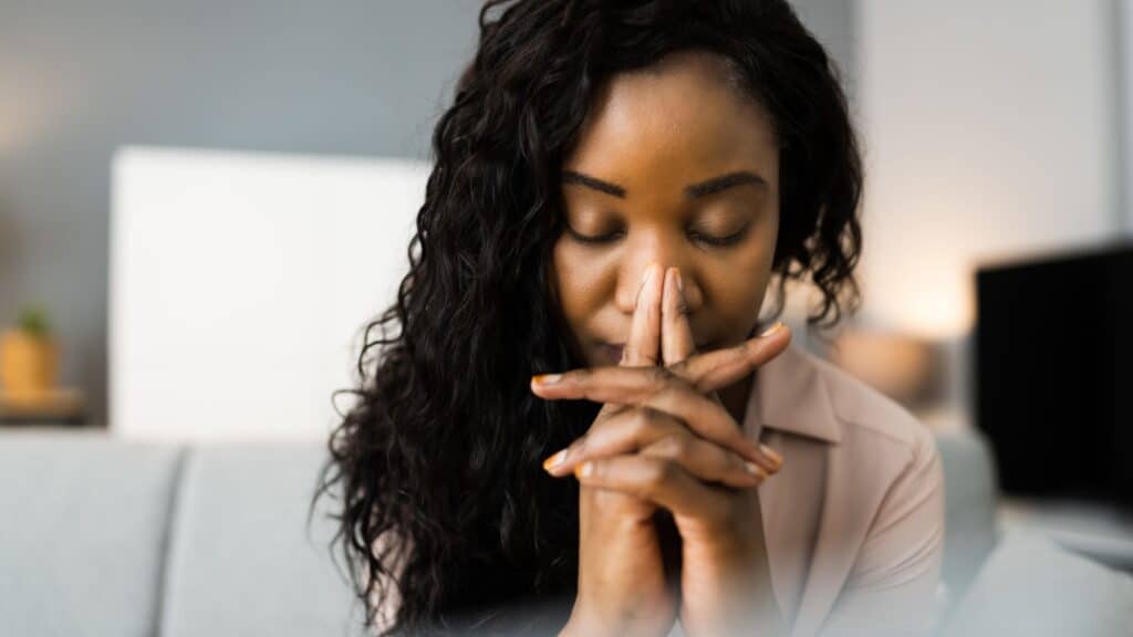 woman with her head bowed in prayer