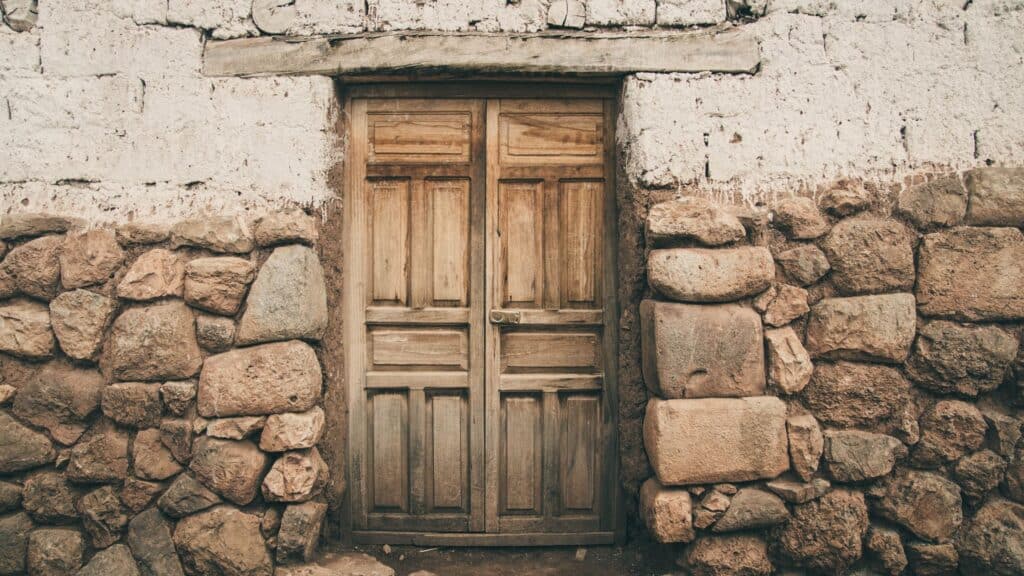 wooden door set in a rock wall