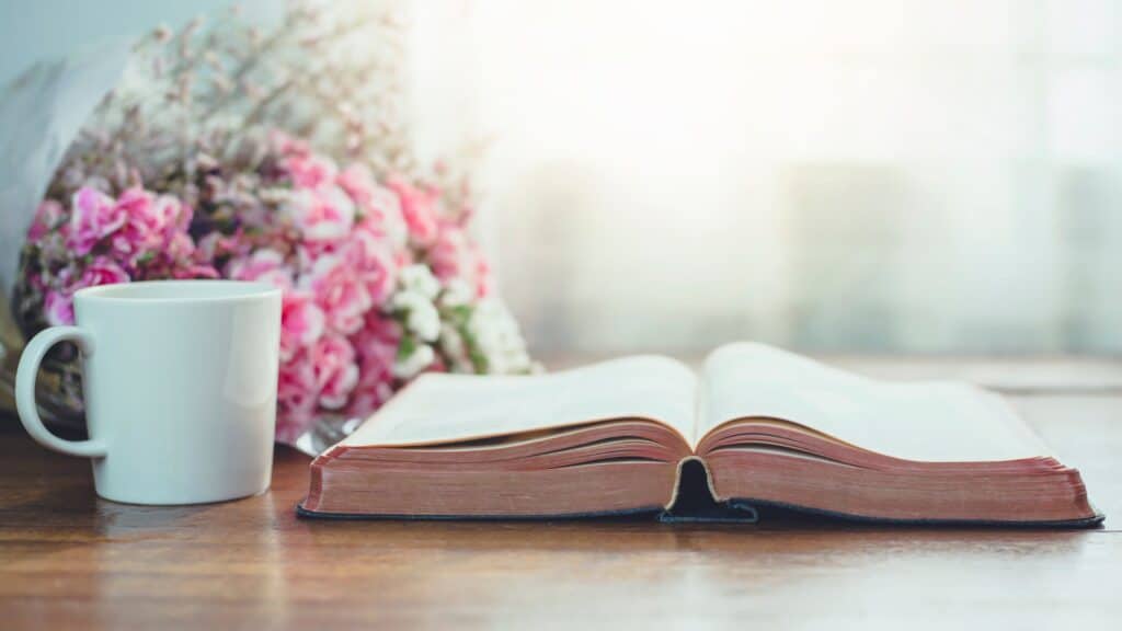 open Bible with flowers and coffee cup