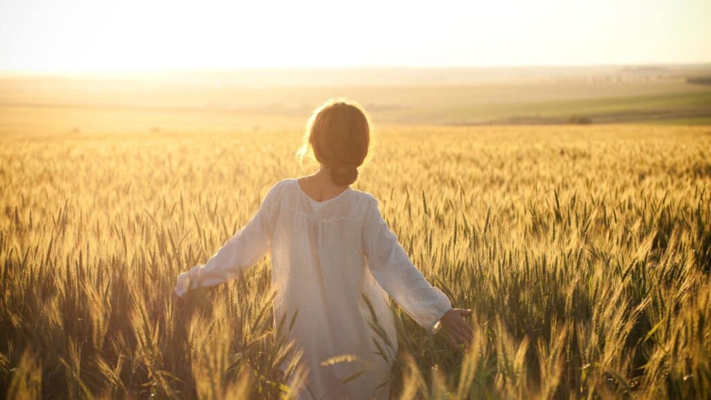 woman walking in a wheat field