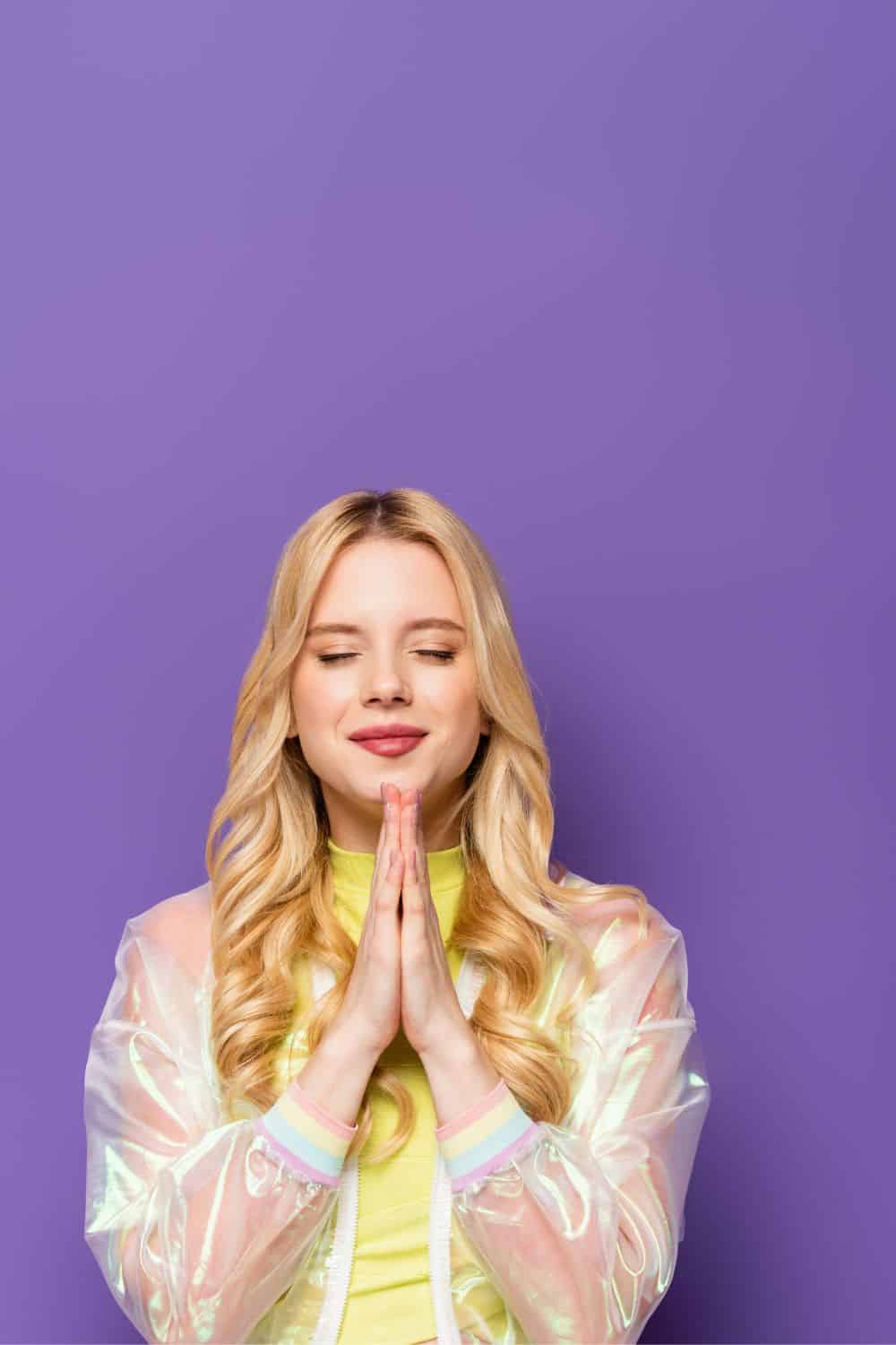 woman with her hands clasped in prayer