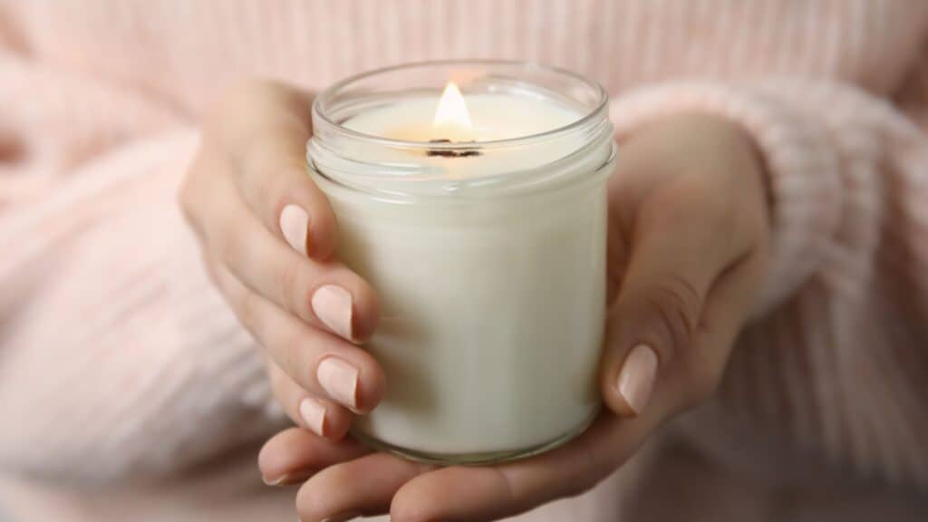 woman's hands holding a candle