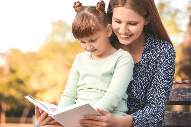 woman and little girl reading thanksgiving bible stories