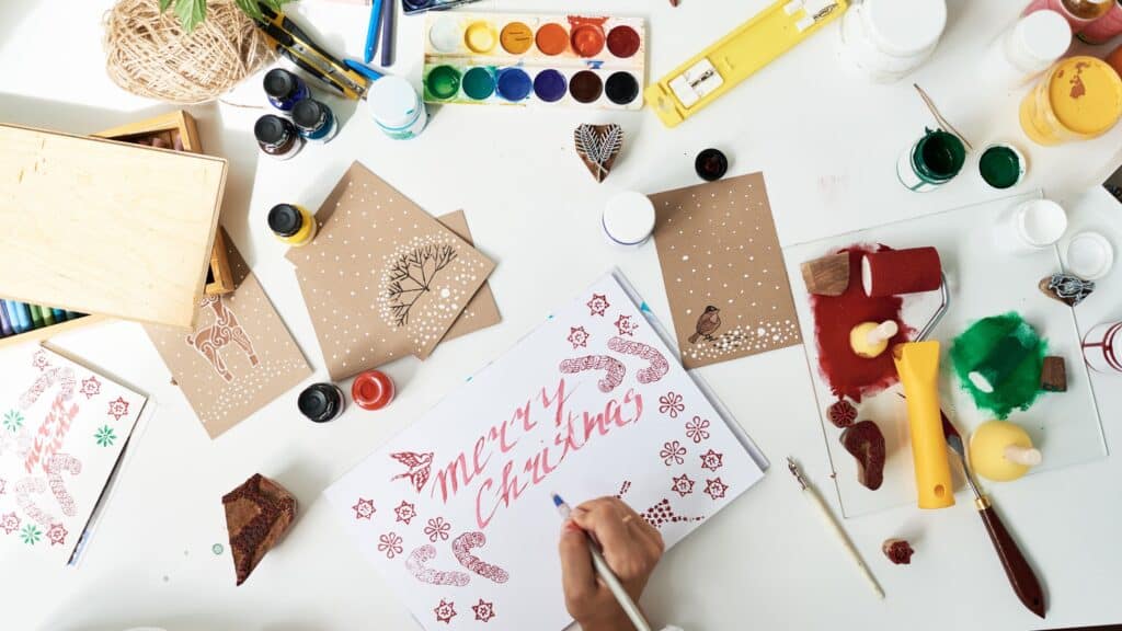 woman writing a message on a Christmas card