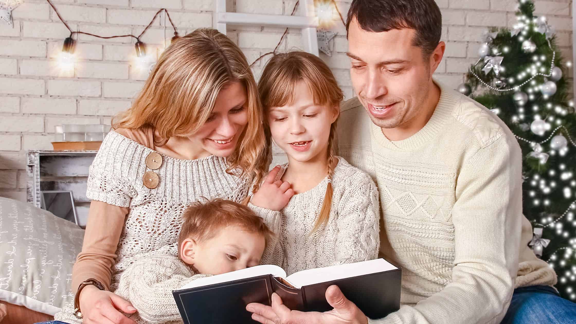 family reading Christmas Bible verses with kids