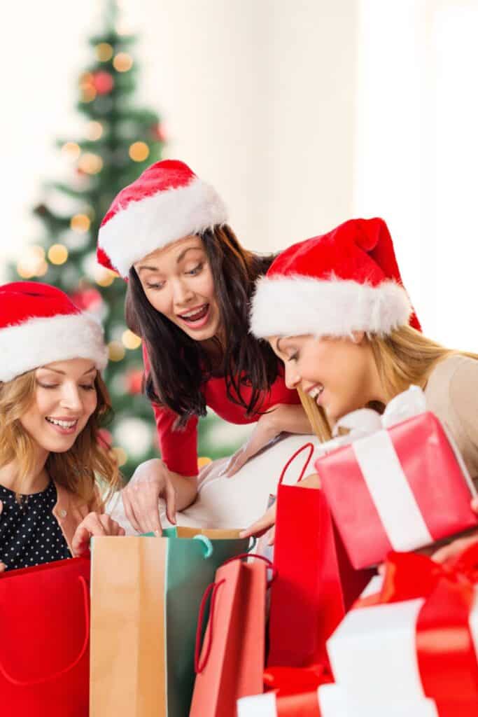 3 mom friends opening gifts at Christmas