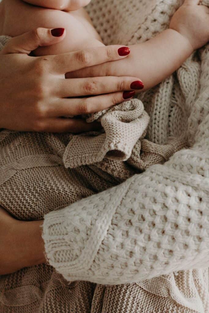 close-up of woman's arms holding a baby