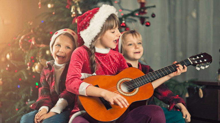 kids playing a guitar and singing at Christmas