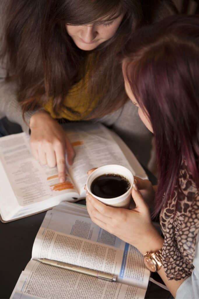 two young women reading the Bible together