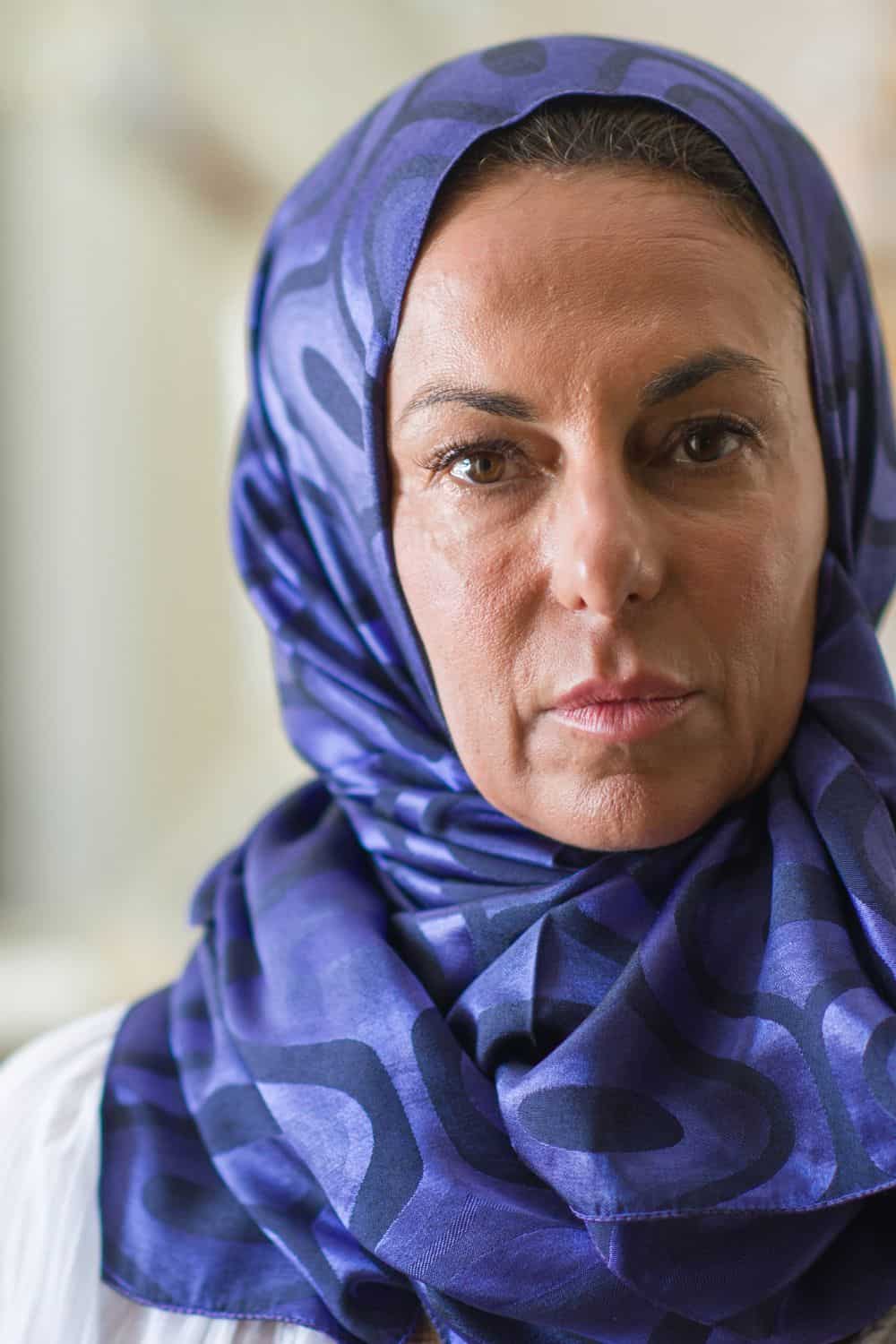 middle Eastern woman wearing a purple head scarf