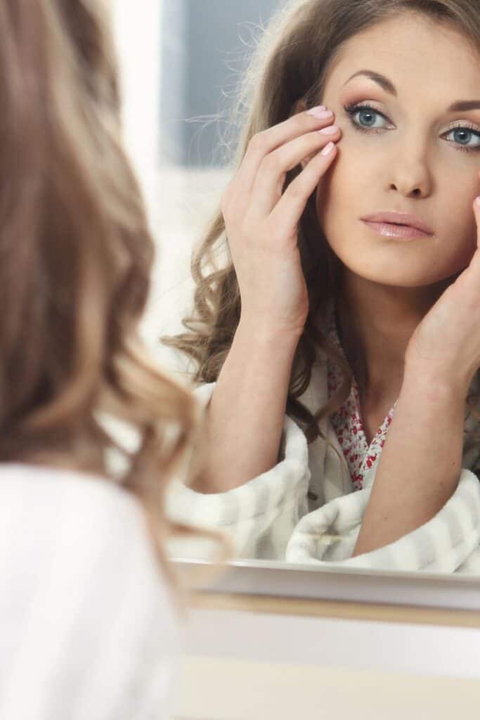 woman looking into a mirror