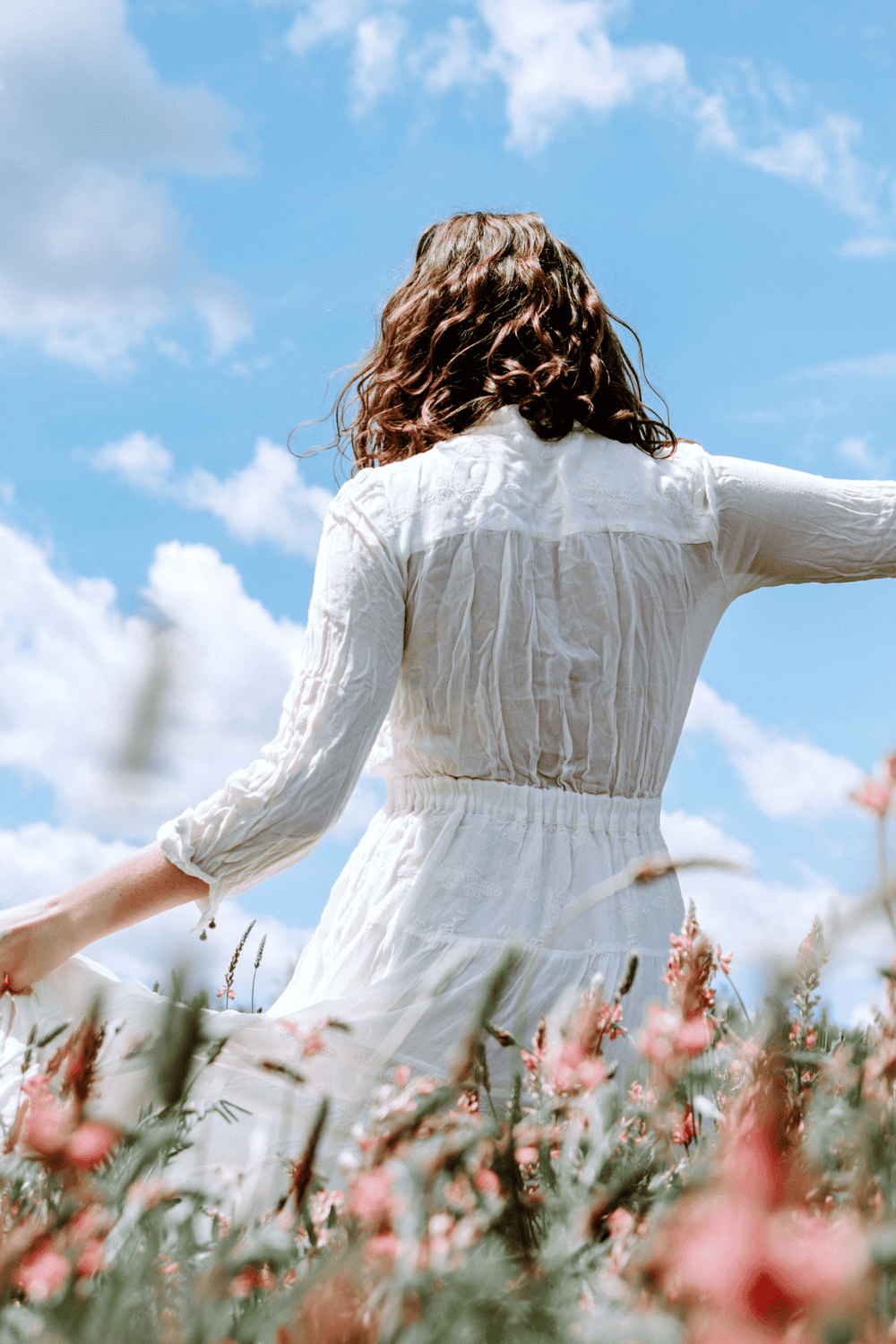 beautiful woman walking in a field