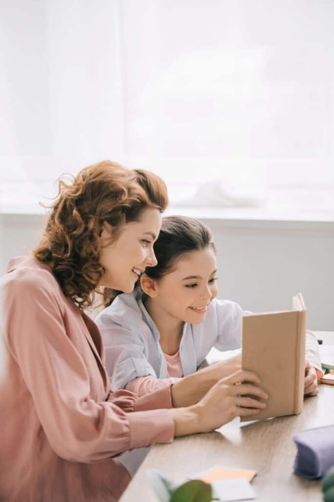 woman and little girl reading together