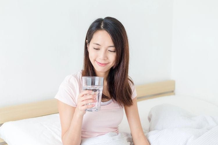 woman drinking water in the morning