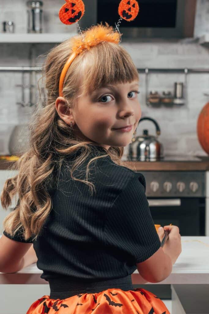 little girl wearing a Halloween costume