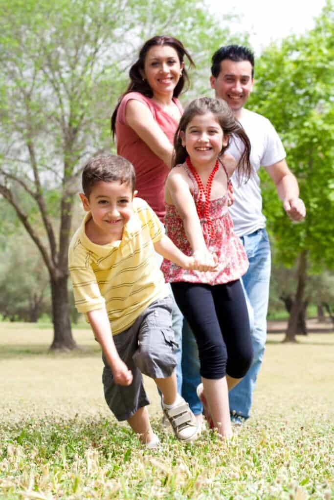 family holding hands and running