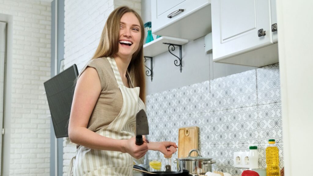 smiling housewife preparing food