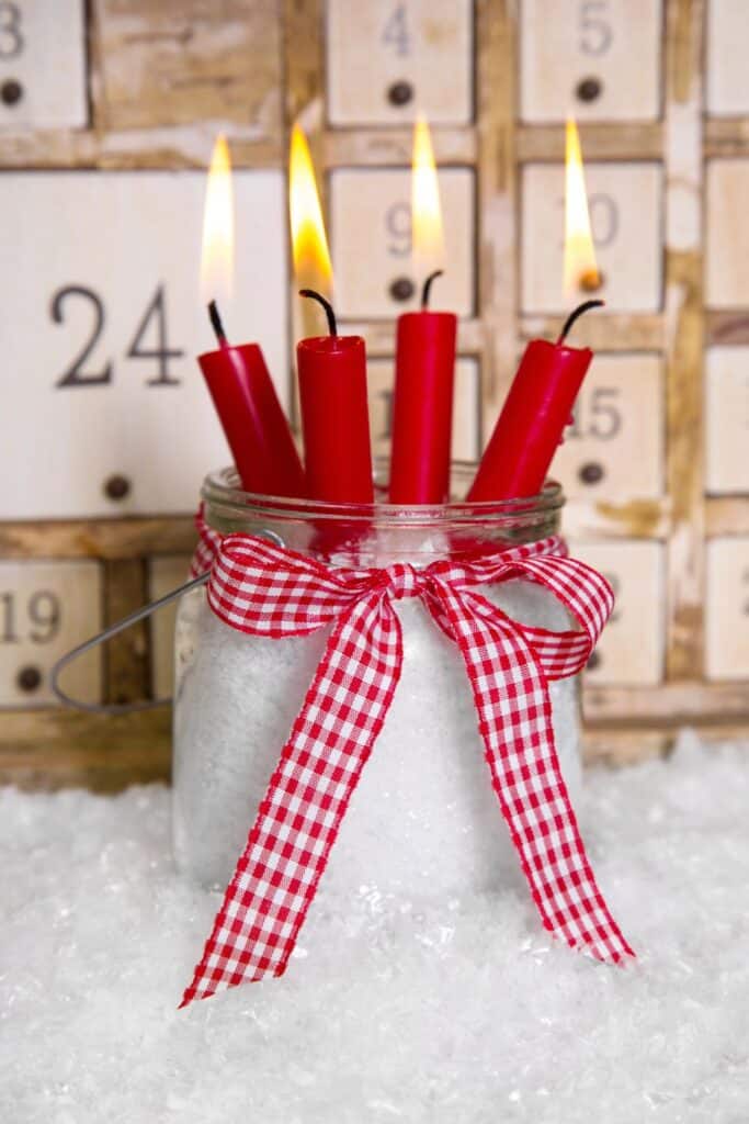 red candles with an Advent calendar in the background