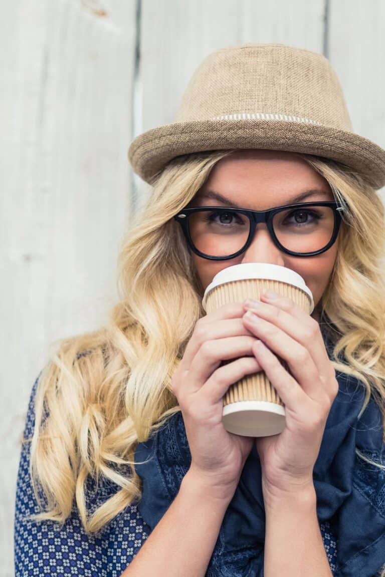 smiling woman holding a coffee cup