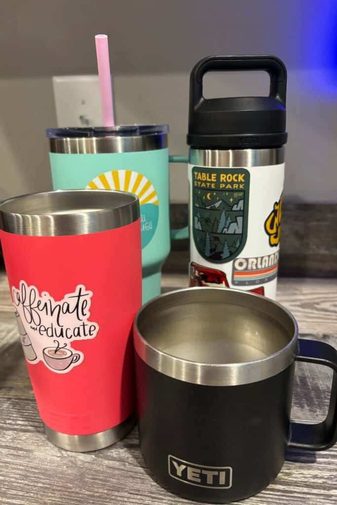 collection of stainless steel coffee tumblers on a counter