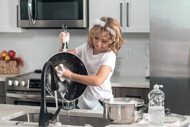 child washing dishes