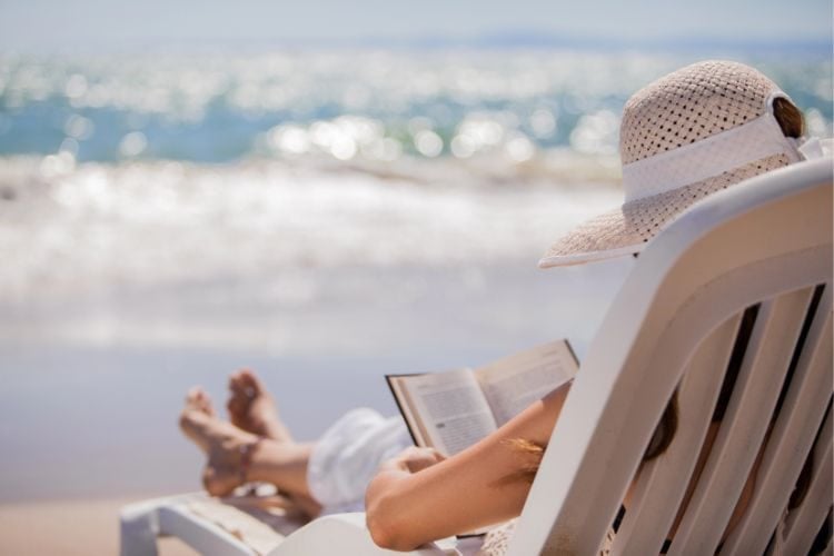woman reading on the beach